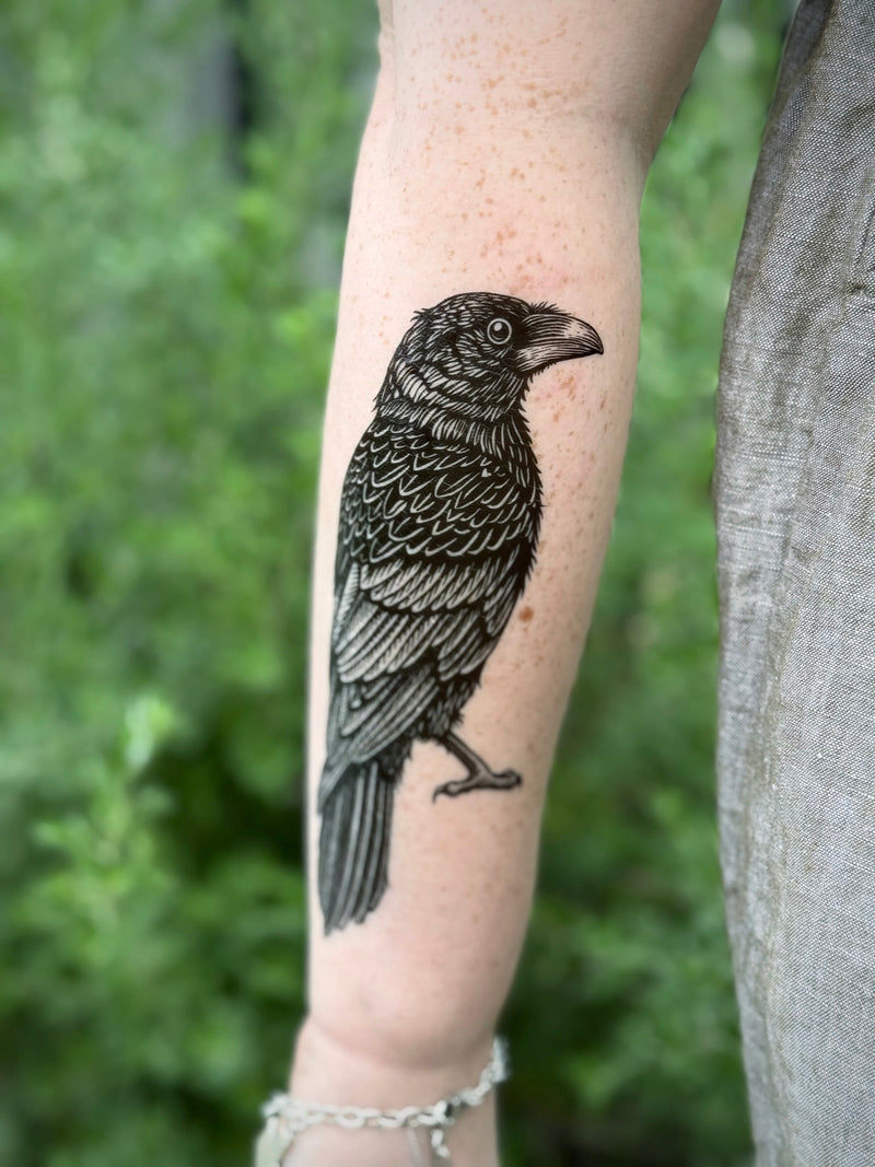 Temporary Tattoo of a bird on a person's arm with a natural background