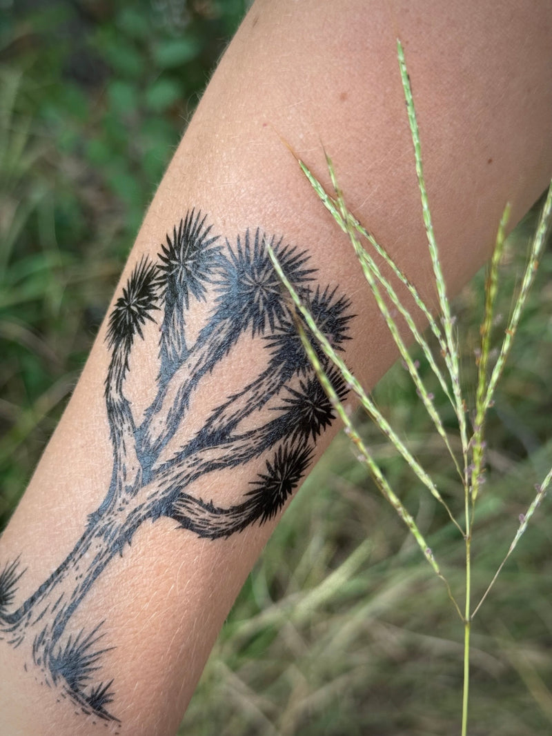 Temporary Tattoo of a joshua tree design on a person's arm with a natural background