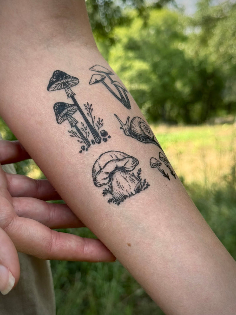 Temporary Tattoo of mushrooms and plants on a person's arm with a natural background