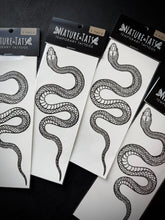 Nature-Tats temporary tattoos with snake design on a black surface