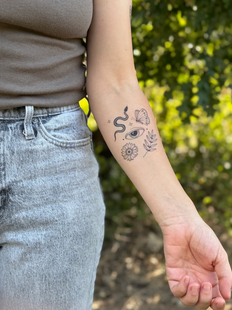 Person with arm temporary tattoos outdoors