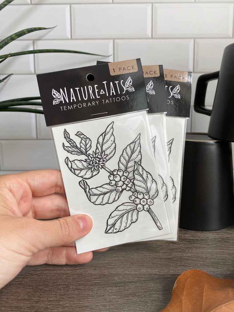 Coffee plant temporary tattoo in packaging with coffee mug background 
