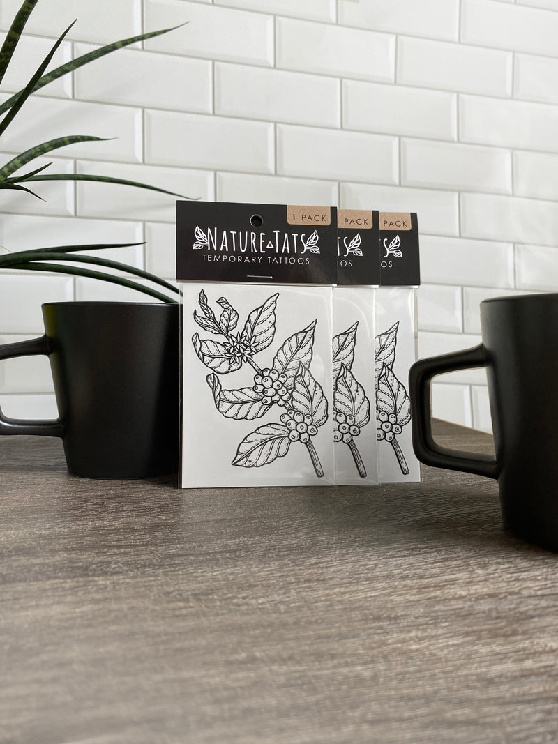 coffee plant temporary tattoo in packaging with coffee mugs background 