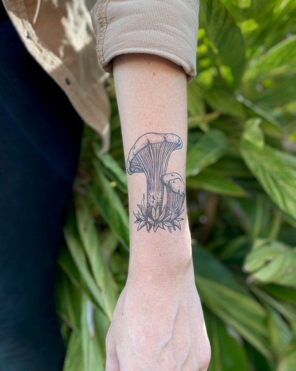 mushroom Temporary tattoo on arm with green leaf background 