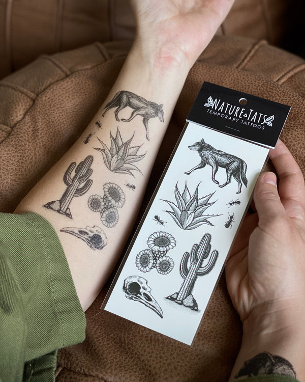desert wild temporary tattoo on arm and in packaging with a brown background 