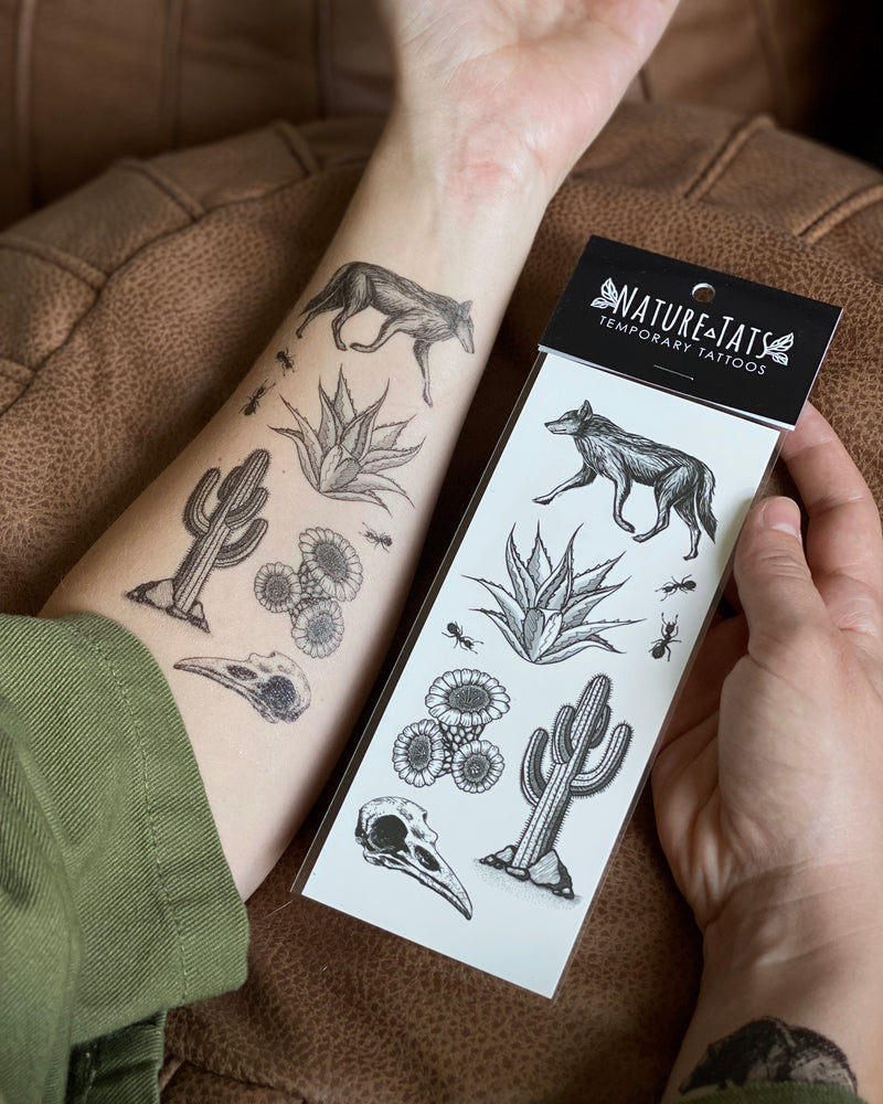 desert wild temporary tattoo on arm and in packaging with a brown background 
