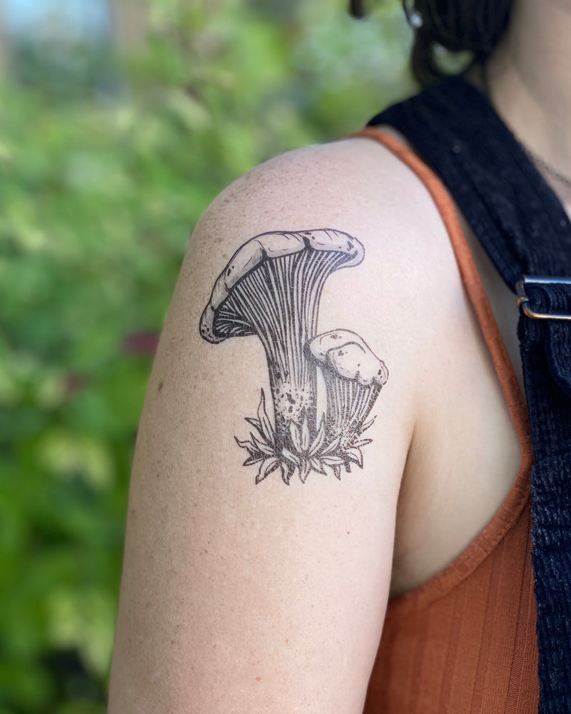 Mushroom Temporary tattoo on shoulder with a blurred nature background 