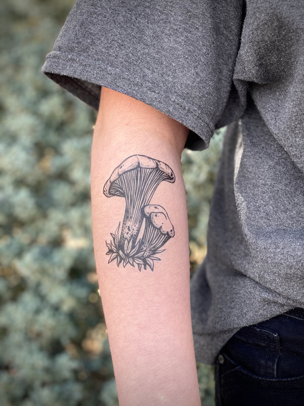 mushroom Temporary tattoo on arm with blurred grey background 