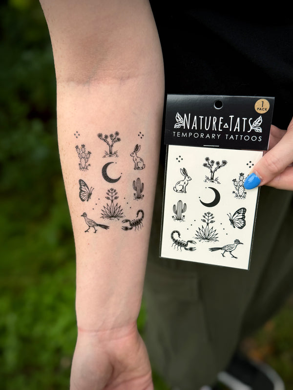 NatureTats temporary tattoos worn on a person's arm with the packaging in the background.
