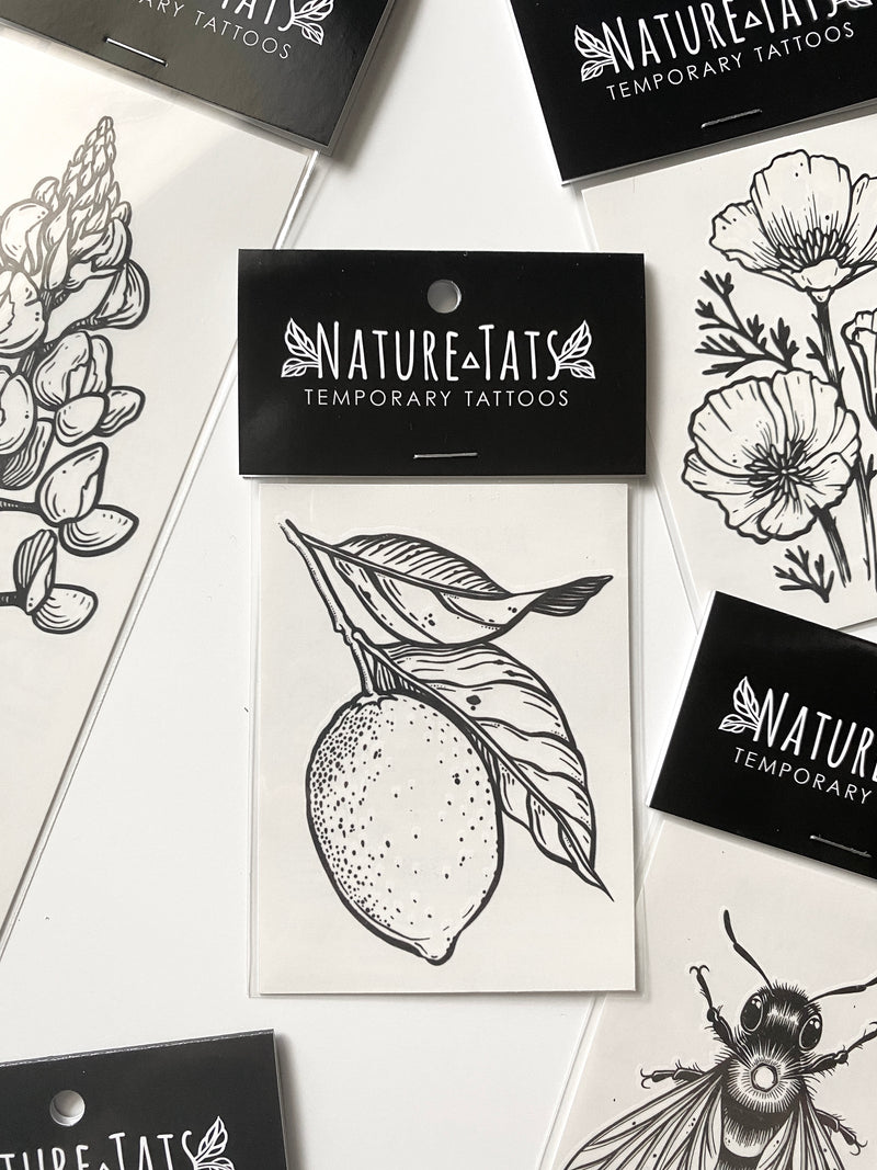 lemon with leaves temporary tattoo in packaging on a white background 
