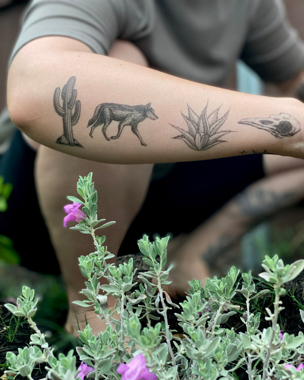 desert wild temporary tattoos on side arm with floral nature background 