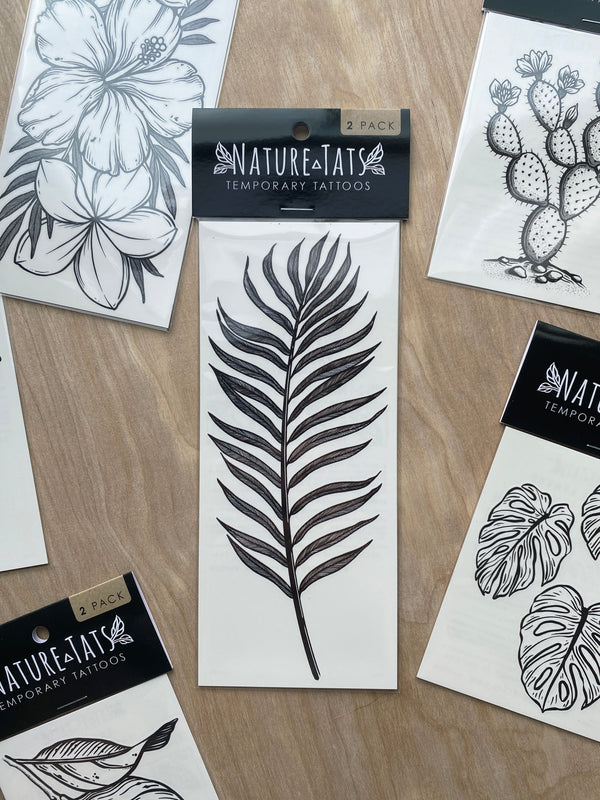 palm leaf temporary tattoo in packaging on a wood background 