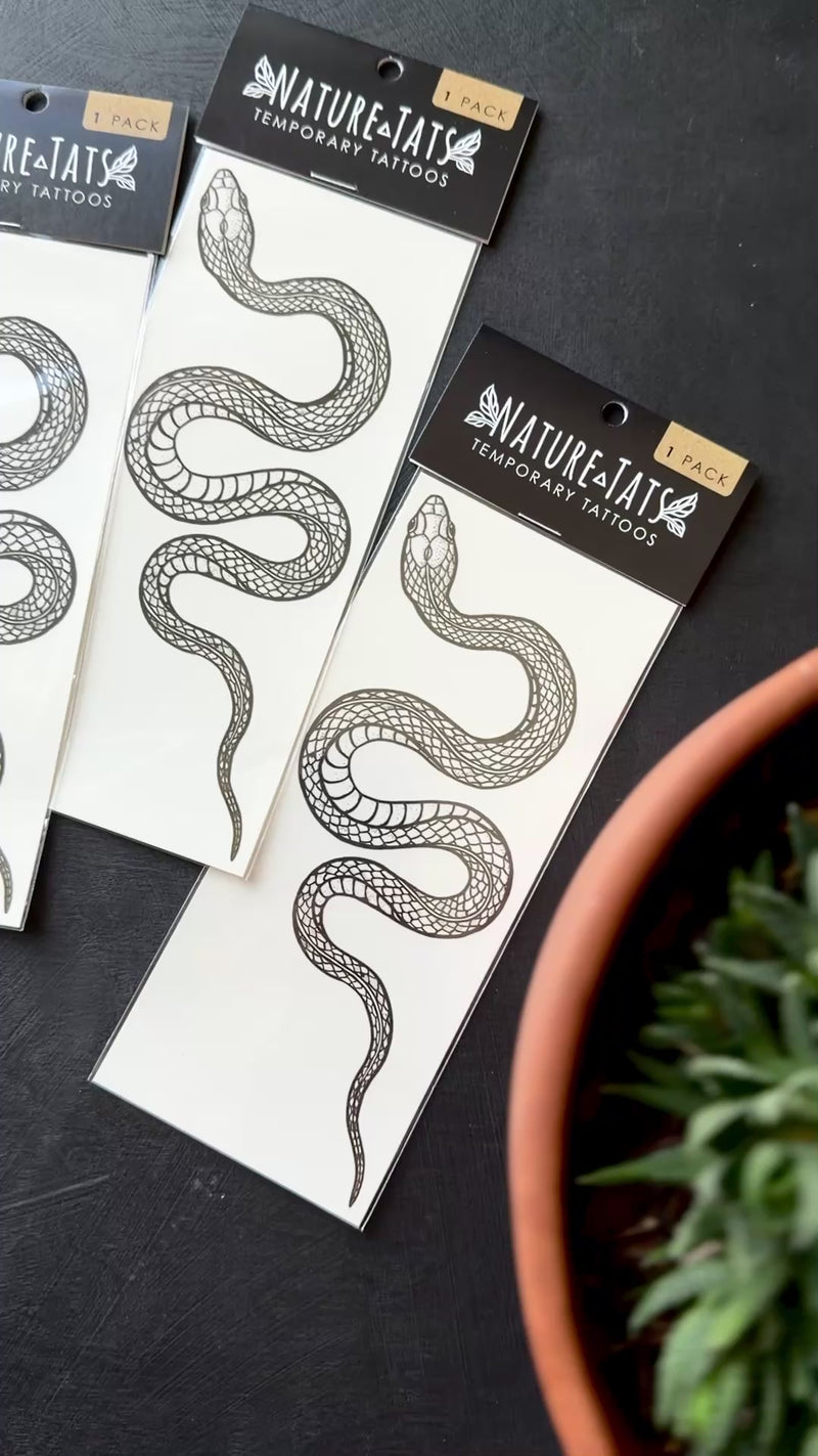 garden snake temporary tattoos in packaging on black background 