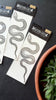 garden snake temporary tattoos in packaging on black background 