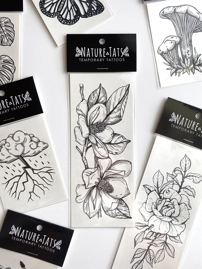 magnolia flowers temporary tattoo in packaging on a white background 