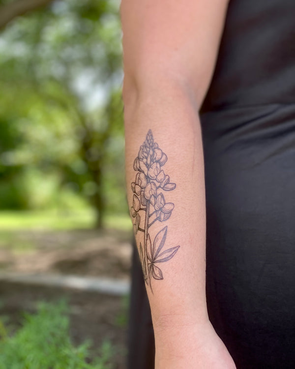 bluebonnet temporary tattoo with a blurred nature background 