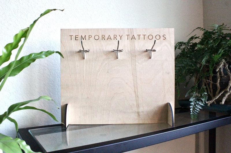 temporary tattoo small stand with no tattoos on it with plants around 