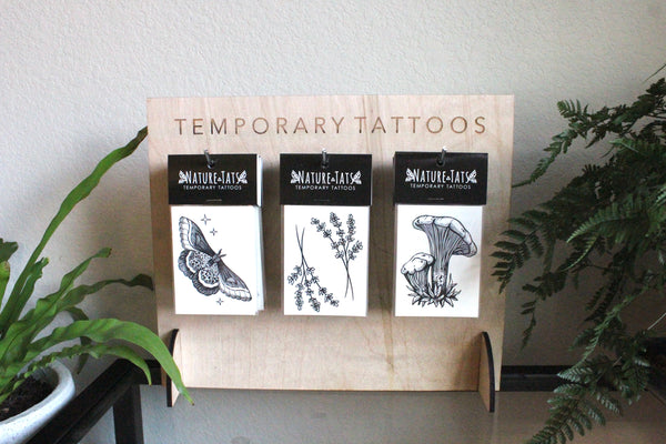 small temporary tattoos with stand and plants around  