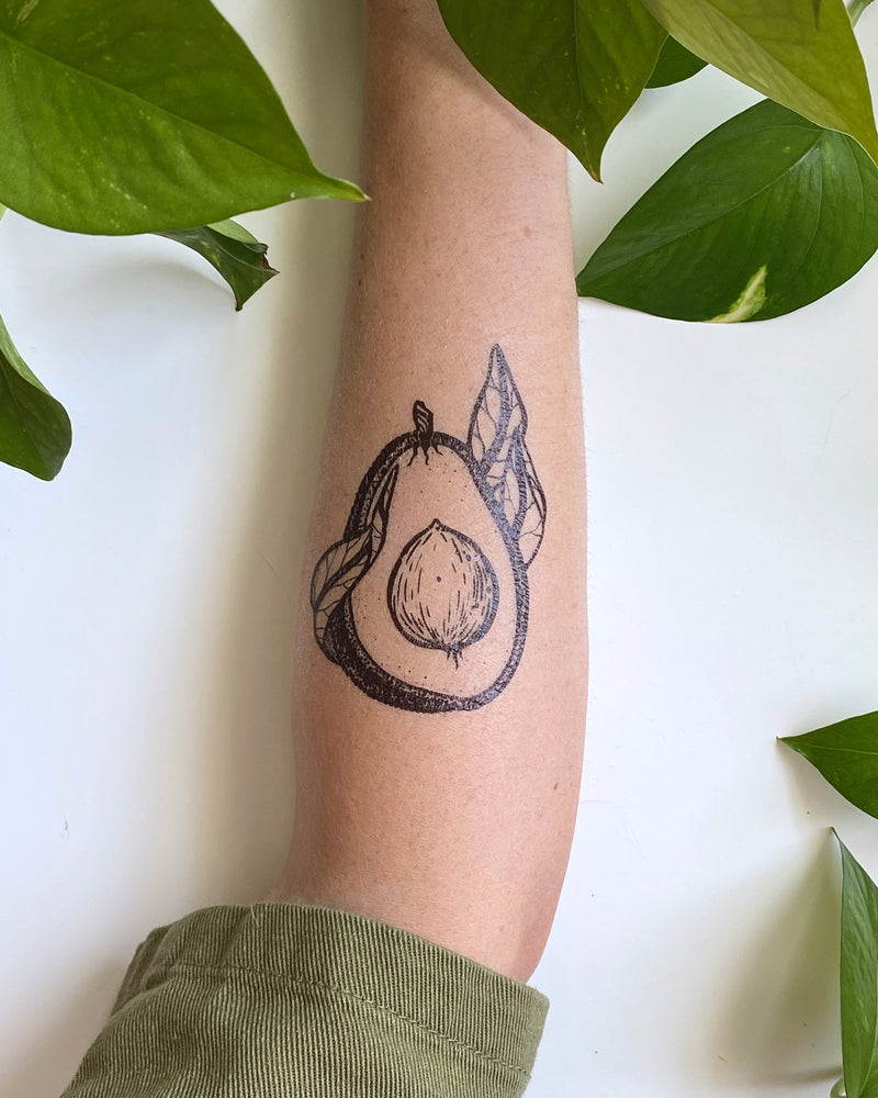 temporary tattoo on a person arm with a white and green nature background 