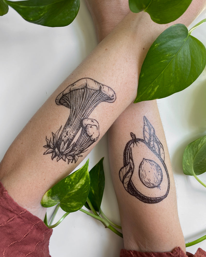 temporary tattoos on a persons arms with a white and green nature background 