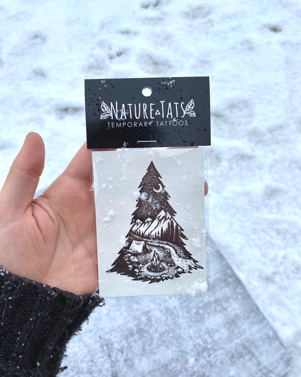 mountain camping temporary tattoo in packaging white a snowy white nature background 