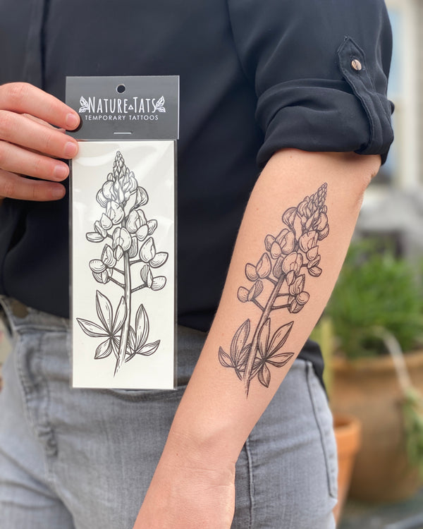 temporary tattoos of bluebonnets with a grey and green nature background 