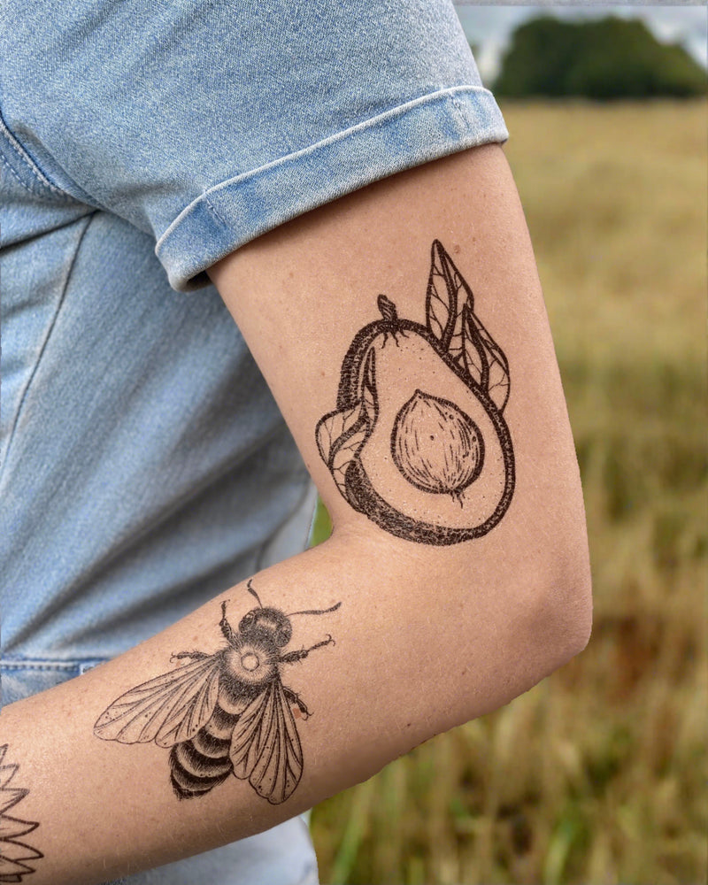 temporary tattoos on a person arm with a nature background 