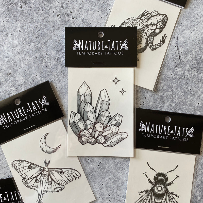 quartz crystal temporary tattoo in packaging on grey background 