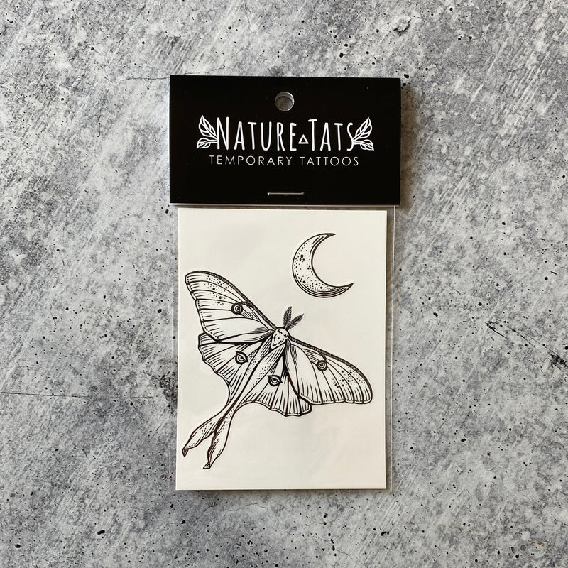 Luna Moth with crescent moon above it temporary tattoo in packaging with a grey background 